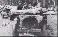 Lieutenant John Howe, commander of the 1st Border's No.25 Anti-Tank Platoon, lying on a stretcher mounted on the front of a British Jeep, being evacuated from Oosterbeek during the truce of Sunday 24th September.