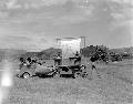 Tenth Mountain Division Information and Education section's Mobile Orientation unit's jeep-top stage parked in the middle of a grassy field.