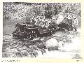 A jeep towing a tank attack gun over the ford constructed by engineers across the Hongorai River