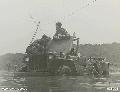 Aitape, New Guinea. 12 January 1945. These two Aussies make a vain attempt to restart their jeep, no. 129361, stalled in mid-stream, without getting their feet wet