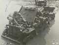 Aitape, New Guinea. 12 January 1945. These two Aussies make a vain attempt to restart their jeep, no. 129361, with logo of a kangaroo over a boomerang