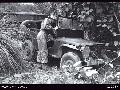 BALIKPAPAN AREA, BORNEO, 22 JULY 1945. LIEUTENANT M G SEARLES, 2_25 INFANTRY BATTALION, INSPECTING A JAPANESE JEEP FOUND ABANDONED ON THE MILFORD HIGHWAY NEAR POPES TRACK.