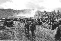 Clearing in a field behind White Beach, Agat Beachhead. Trucks and jeeps load while troops advance inland.Prior to July 28.