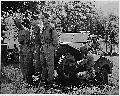 Boys lifting jeep to repair it at their bivouac area near Manchester, US. 06 1941