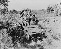 Fort Benning, Georgia. West Point cadets and a soldier driving a jeep.1942