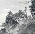 Wadesboro, North Carolina. Jeep on maneuvers crossing rough terrain pulling a thirty-seven millimeter anti-tank gun.