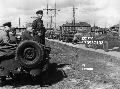 A commander of a soviet tank destroyer unit watching the column pass,the american jeeps, sent as part of the lend-lease program, were very popular with the russians, world war ll