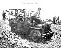 Wounded U.S. marines are loaded in the back of a jeep as it spins through the mud inland from the beach on Bougainville Island in the southwest Pacific Solomon Islands in 1944