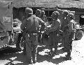 A wounded Marine is brought into a forward aid station by a jeep ambulance, Korea, 3 September 1950