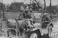 DEORA US 2nd Armored Div. showing off 3 eggs and 2 German prisoners of war he found in a barn on the road to Lippestadt during the Allied drive towards Berlin.Germany 1945