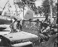 USN 120677 GPW 1944 American air crew in Willys Jeep with Corsair F4U in the background on Falalop island, Ulithi Atoll.