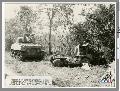  Combat photographers jeep crushed tank under fire enemy anti tank guns Cabarvan hills Luzon, Philippines. (http://www.ww2online.org)