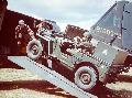 A jeep, equipped with a portable radio is loaded onto a C-47 for transport to France. England - 1944